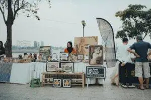 A vibrant street market along the riverside in Phnom Penh, showcasing Cambodian art and crafts.